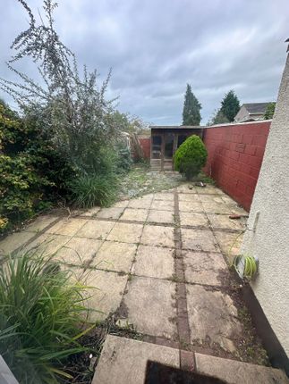 A Private Garden Featuring A Paved Patio Area With...