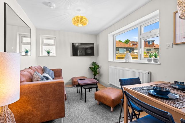 Bright And Stylish Living Room Featuring A Comfort...