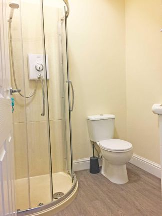 Bright, Modern Bathroom With A Curved Glass Shower...