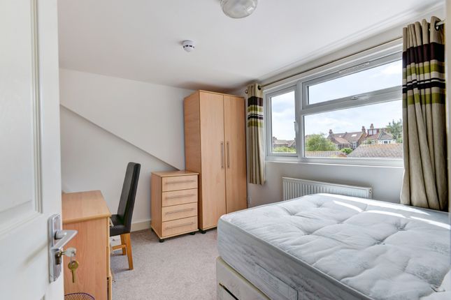 A Bright And Tidy Single Bedroom Featuring A Large...