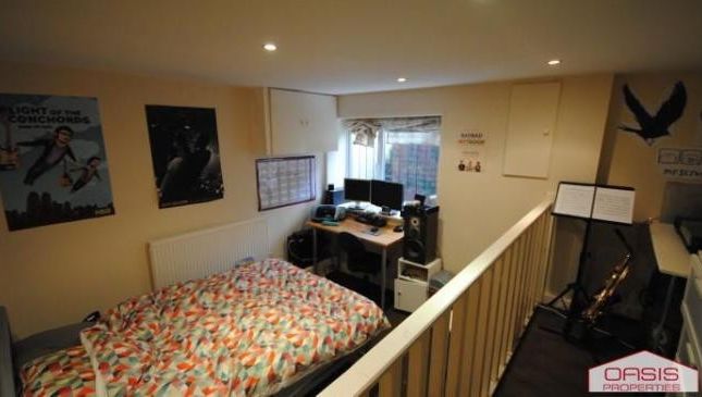 Well-Lit Bedroom Featuring A Comfortable Double Be...