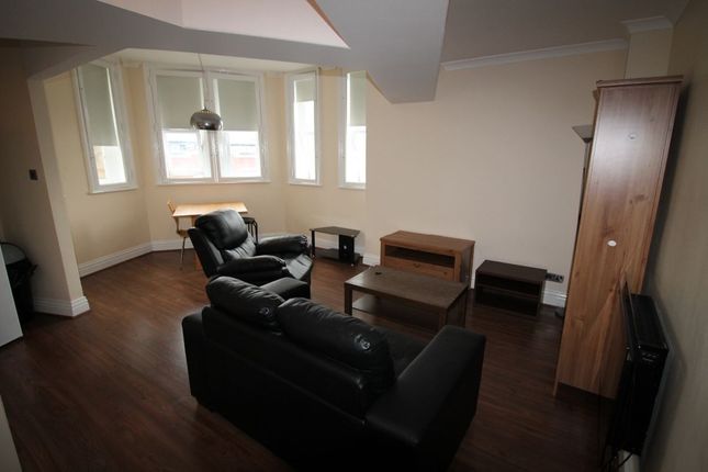 A Modern Living Room With Dark Wooden Flooring And...