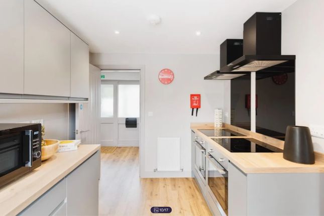 A Modern And Clean Kitchenette Featuring Sleek Cab...