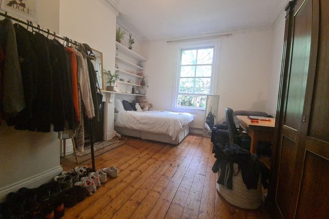 A Cozy And Neatly Organized Bedroom Featuring A Si...