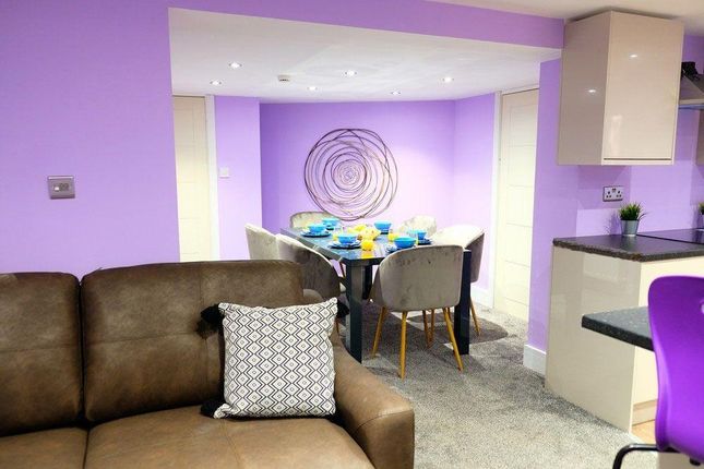 A Cozy Living Room Area Featuring A Comfortable Br...