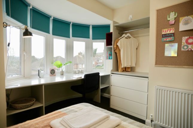 A Bright And Well-Lit Bedroom With A Large Bay Win...