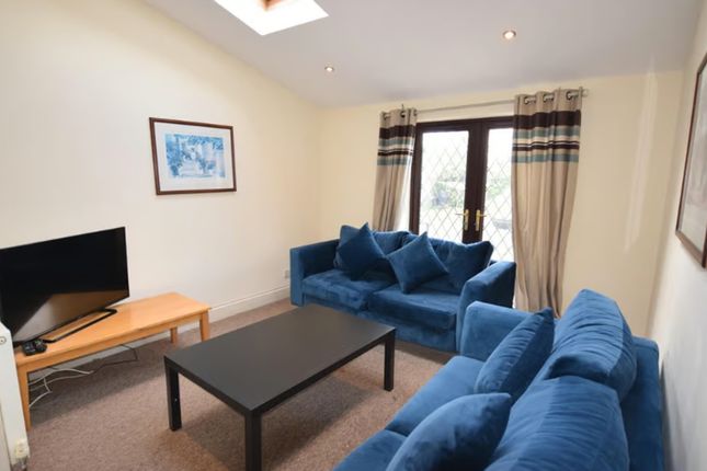 Spacious And Inviting Living Room Featuring Comfor...