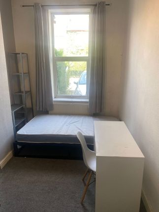 A Cozy And Bright Single Bedroom With A Large Wind...