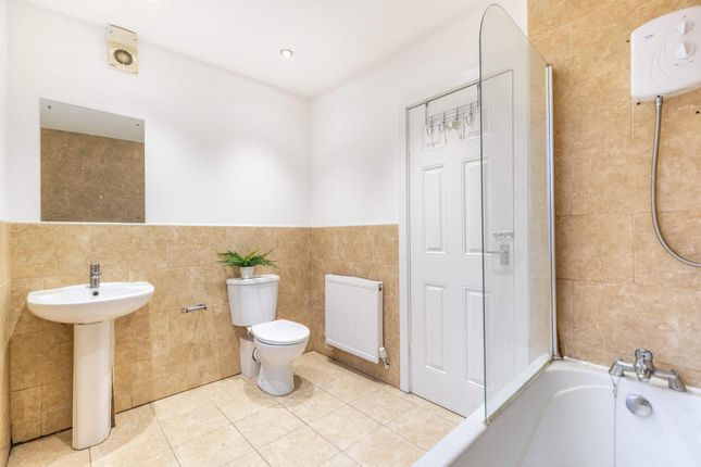 A Clean And Well-Lit Bathroom With A Modern Bathtu...