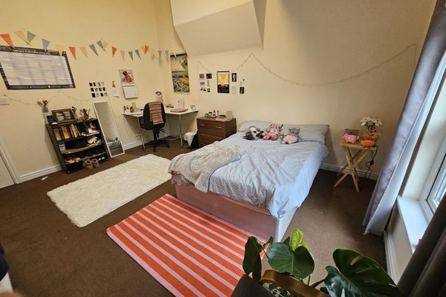 A Cozy Bedroom Featuring A Double Bed With A Light...
