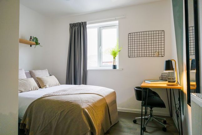 A Bright And Inviting Double Bedroom With A Cozy A...