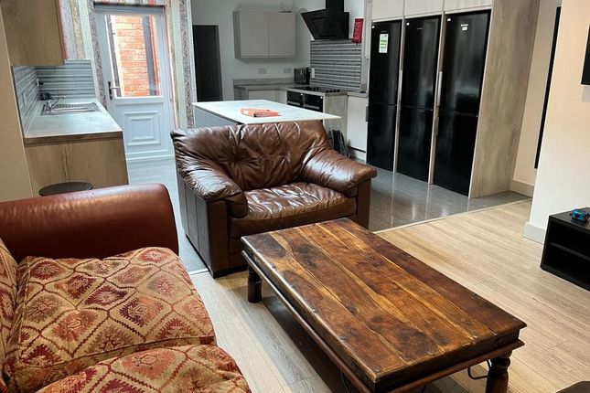 A Spacious And Well-Lit Living Room Featuring A mi...