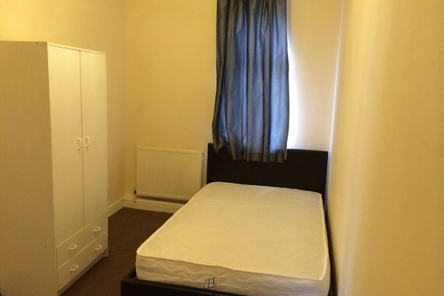 A Cozy Bedroom Featuring A Single Bed, A Wardrobe,...