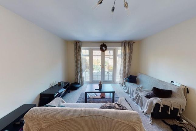 A Cozy Living Room With A Large Window Allowing Na...