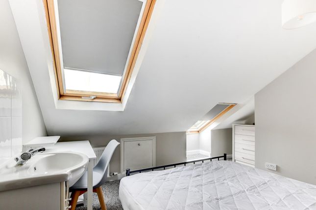 Bright And Airy Bedroom Featuring A Skylight Windo...