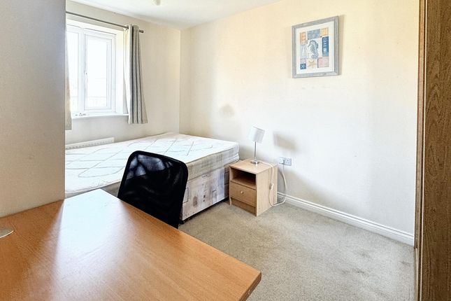 A Bright And Tidy Bedroom Featuring A Bed, Desk, A...