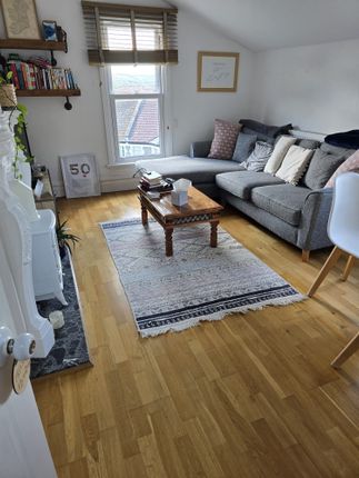 Bright And Inviting Living Room Featuring A Cozy G...