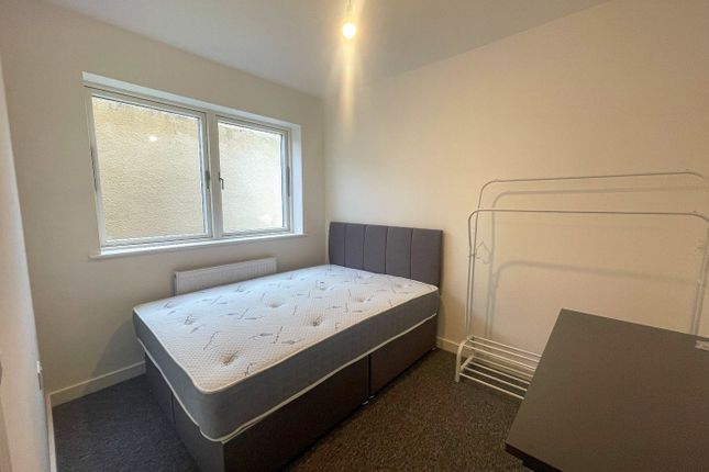 This Cozy Double Bedroom Features A Comfortable Be...
