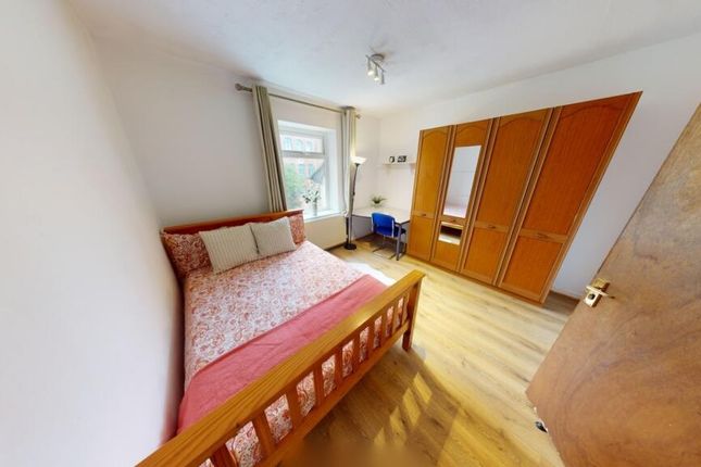 Bright And Inviting Master Bedroom With A Comforta...