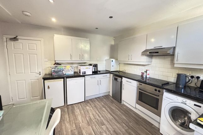 A Modern, Well-Lit Kitchen Area Featuring White Ca...