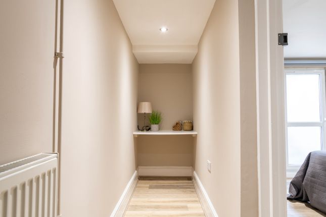 A Well-Maintained Hallway Featuring Modern Decor A...