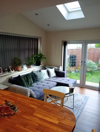 A Bright And Inviting Living Room Featuring A Comf...