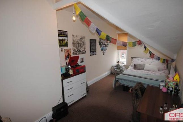 A Cozy Bedroom With A Single Bed, Decorated With P...