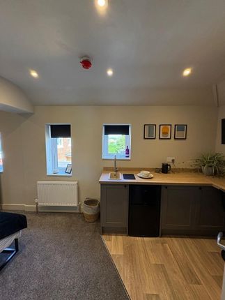 A Modern, Compact Studio Space Featuring A Neat Ki...