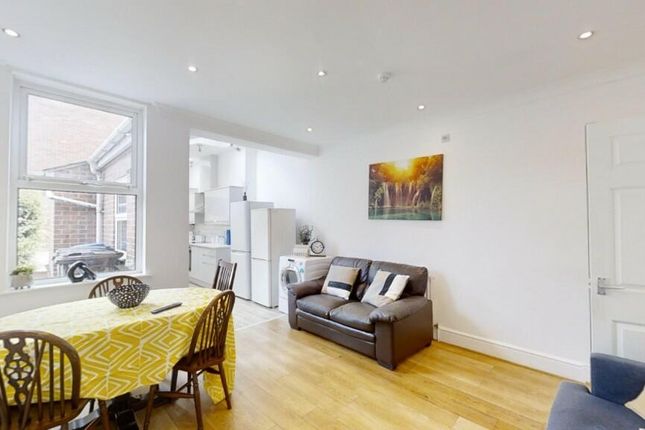 A Bright And Welcoming Living Room Featuring A Coz...