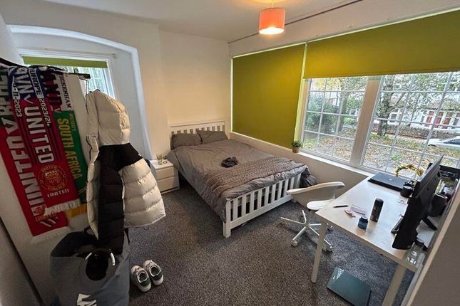 A Bright, Well-Maintained Bedroom Featuring A Doub...