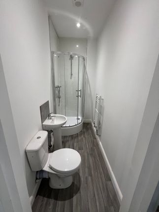 A Modern Bathroom Featuring A Curved Glass Shower ...