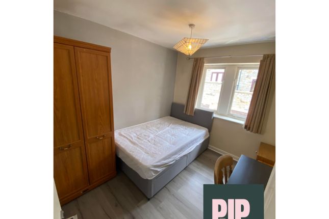 A Cozy Double Bedroom Featuring Ample Natural Ligh...