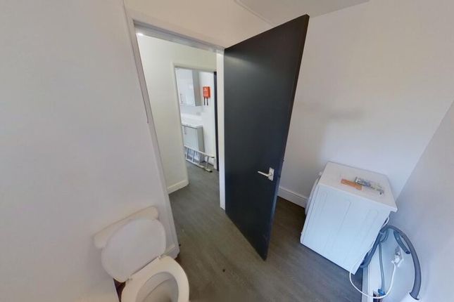A Clean And Simple Single Toilet Room Featuring A ...