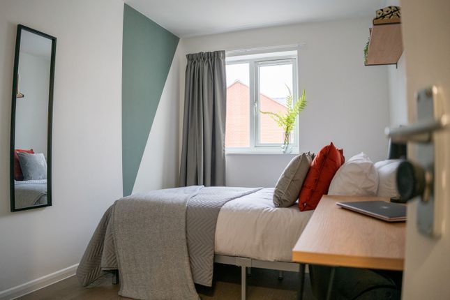 A Bright And Tidy Double Bedroom Featuring A Comfo...