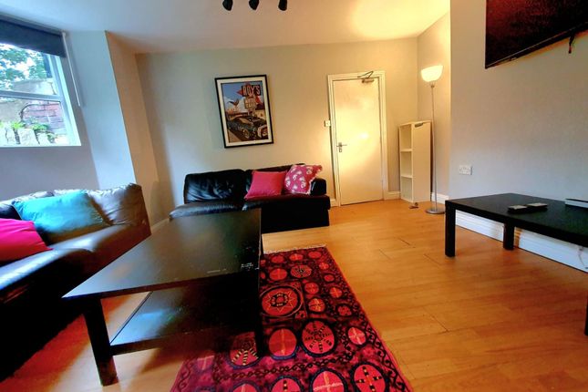 A Cozy And Inviting Living Room With Warm Wooden F...