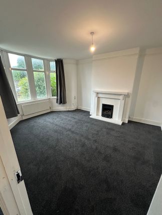 A Bright And Inviting Living Room Featuring A Larg...