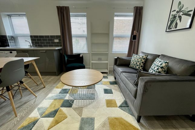 A Bright And Inviting Living Room Featuring A Comf...