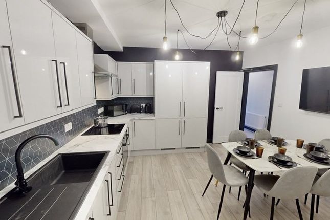 Modern Kitchen With Sleek White Cabinetry, A Spaci...