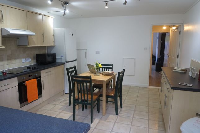 A Bright And Clean Kitchen Featuring A Compact Din...