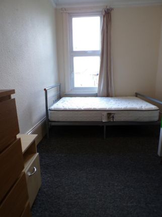 A Cozy Double Bedroom Featuring A Large Window Tha...