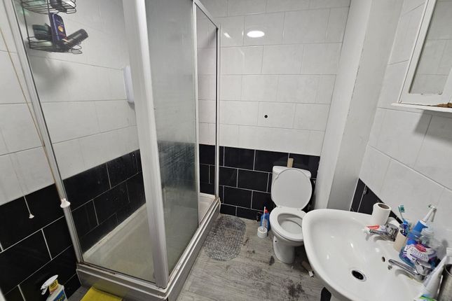 A Clean And Modern Bathroom Featuring A Shower Enc...