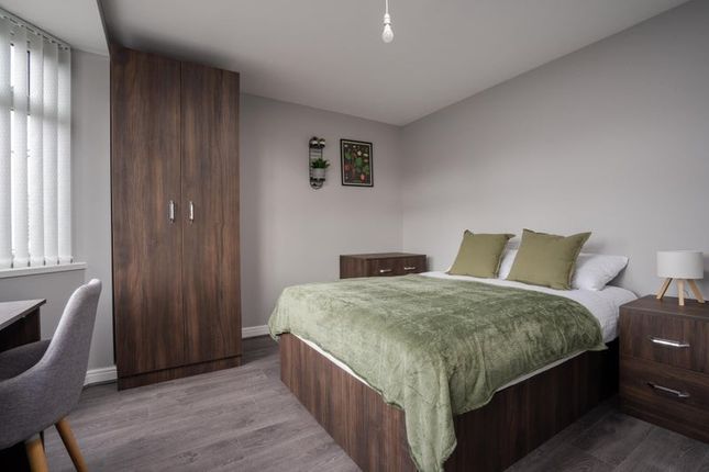 A Cozy Double Bedroom Featuring A Comfortable Bed ...