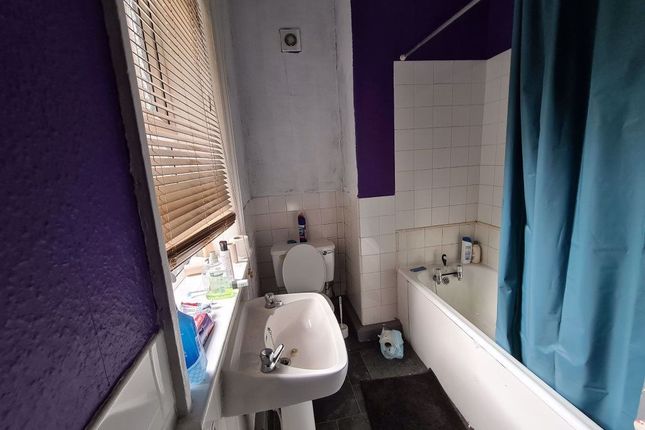 A Neat And Functional Bathroom Featuring A White B...