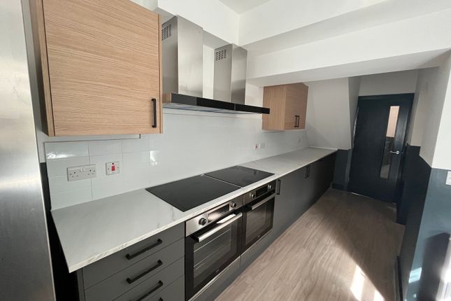 A Modern And Spacious Kitchen Featuring Ample Stor...