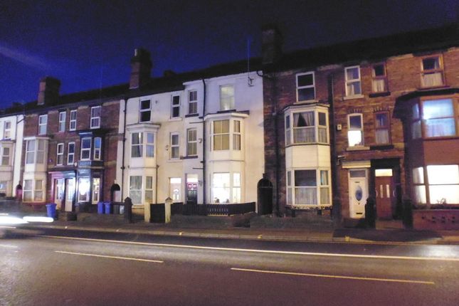 A Nighttime Street View Of A Charming Row Of Terra...