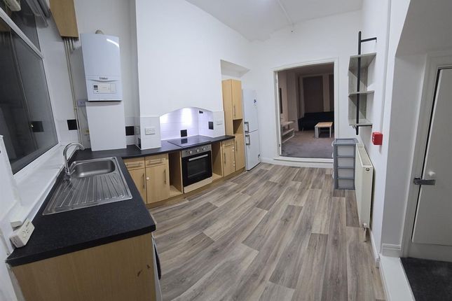 A Spacious And Modern Kitchen Area With Ample Coun...