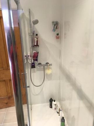 A Modern Bathroom Featuring A Spacious Shower With...