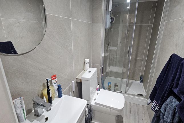 A Clean And Modern Bathroom Featuring A Toilet, Si...