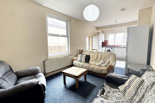 A Bright And Spacious Living Room Featuring Comfor...