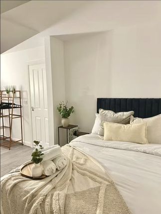 A Beautifully Styled Master Bedroom Featuring A Pl...